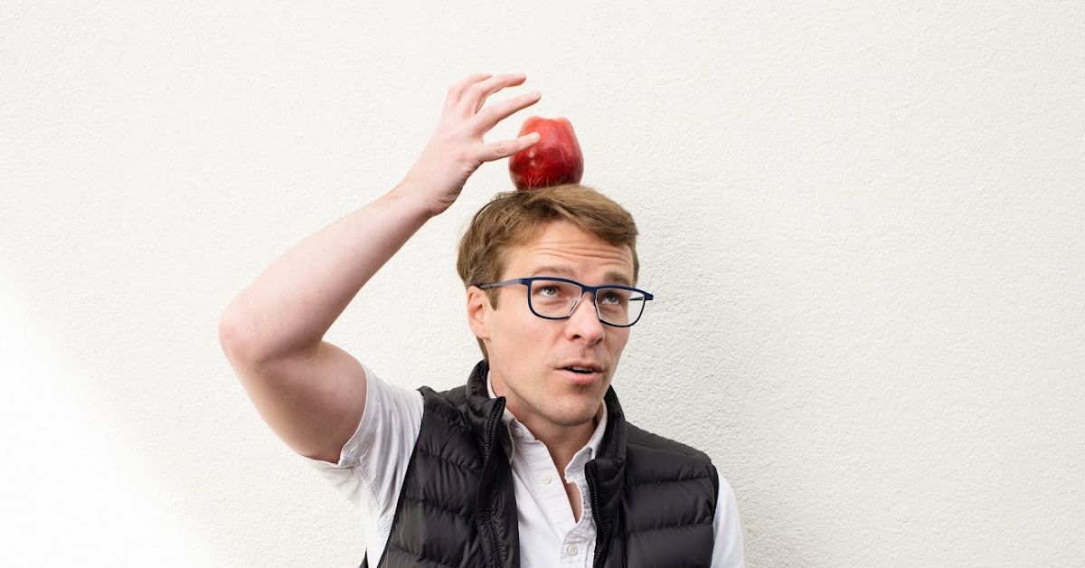 A photo of Josh balancing an apple on his head.